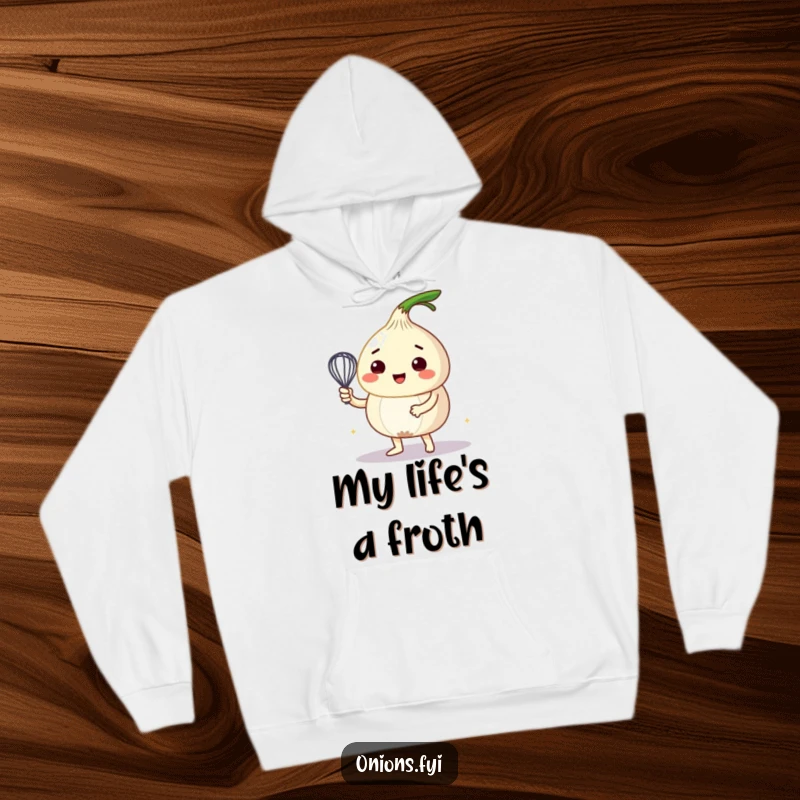 Funny hoodie featuring a cheerful onion character diligently whipping a vibrant bubbly mixture with a tiny whisk, embodying kitchen magic.