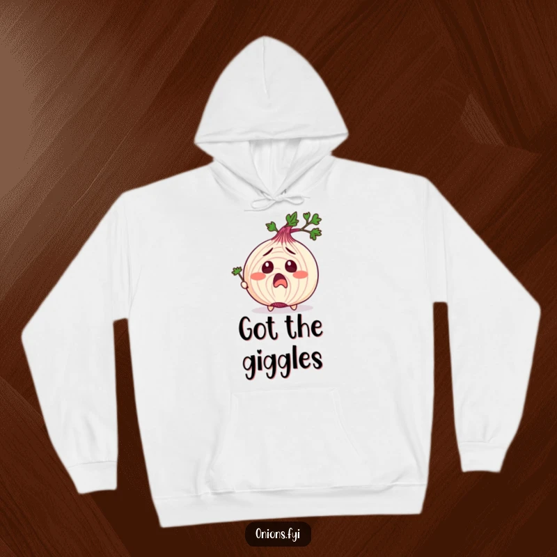 Funny hoodie showing an onion character with exaggerated surprise, being tickled by a parsley sprig, ideal for a cozy funny gift.
